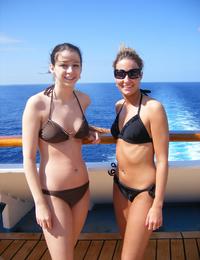 A tanned girl going topless on the Nugal Image 4