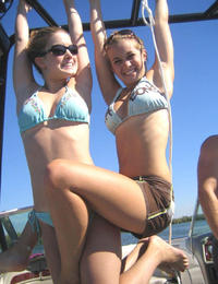A tanned girl going topless on the Nugal Image 5