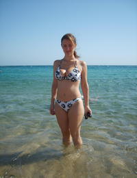 A tanned girl going topless on the Nugal Image 7