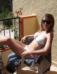 A tanned girl going topless on the Nugal Image 9